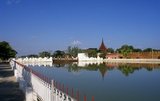 Mandalay Fort's almost 3km (2 miles) of walls enclose King Mindon's palace. The walls rise 8m (26ft).<br/><br/>

The palace was constructed, between 1857 and 1859 as part of King Mindon's founding of the new royal capital city of Mandalay. The plan of Mandalay Palace largely follows the traditional Burmese palace design, inside a walled fort surrounded by a moat.<br/><br/>

The palace itself is at the centre of the citadel and faces east. All buildings of the palace are of one storey in height. The number of spires above a building indicated the importance of the area below.<br/><br/>

Mandalay, a sprawling city of more than 1 million people, was founded in 1857 by King Mindon to coincide with an ancient Buddhist prophecy. It was believed that Gautama Buddha visited the sacred mount of Mandalay Hill with his disciple Ananda, and proclaimed that on the 2,400th anniversary of his death, a metropolis of Buddhist teaching would be founded at the foot of the hill.